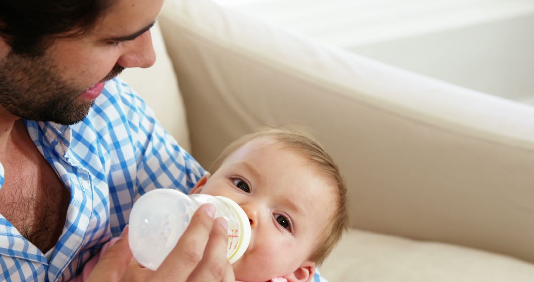 Loving Father Feeding Baby Bottle Milk at Home - Free Images, Stock Photos and Pictures on Pikwizard.com