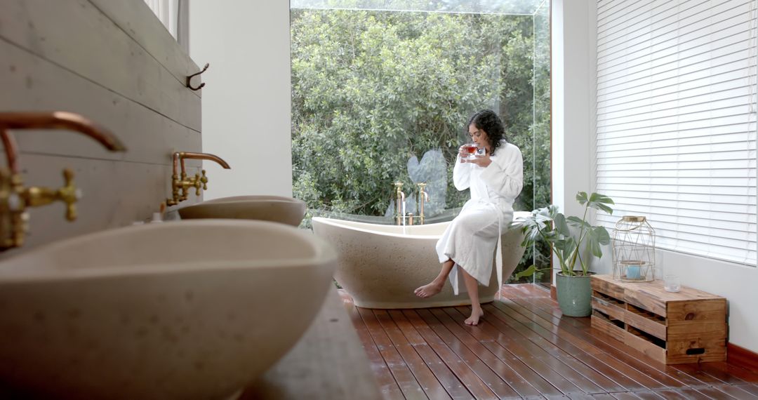 Woman Relaxing in Modern Bathroom with Garden View - Free Images, Stock Photos and Pictures on Pikwizard.com