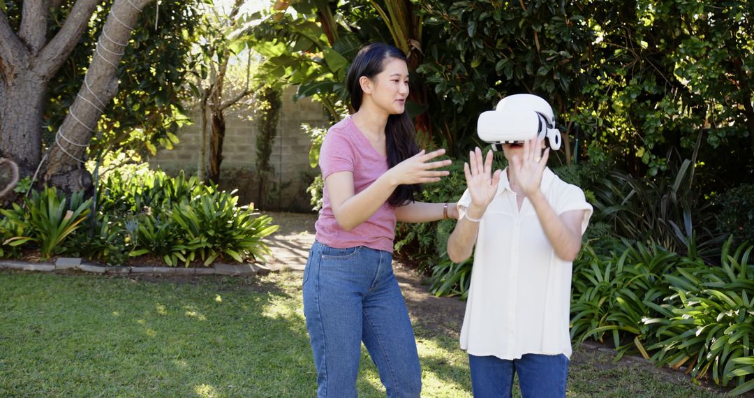 Mother and Daughter Enjoy Virtual Reality in Lush Garden