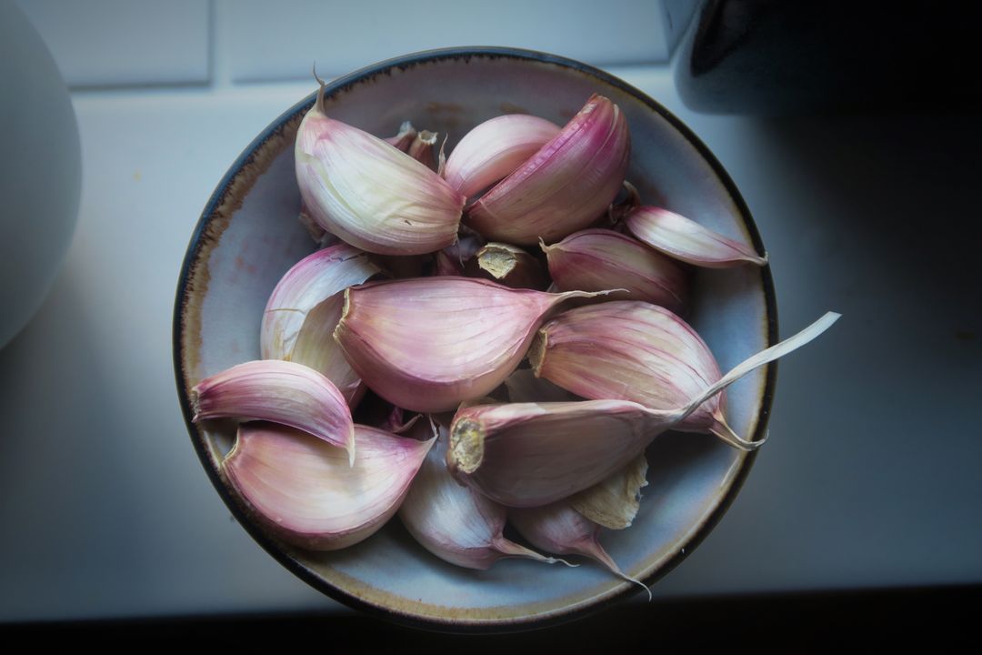 Fresh Garlic Cloves in Ceramic Bowl on White Surface - Free Images, Stock Photos and Pictures on Pikwizard.com