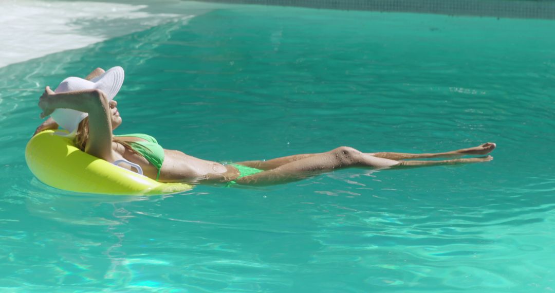 Woman Relaxing on Float in Pool Wearing Sun Hat - Free Images, Stock Photos and Pictures on Pikwizard.com