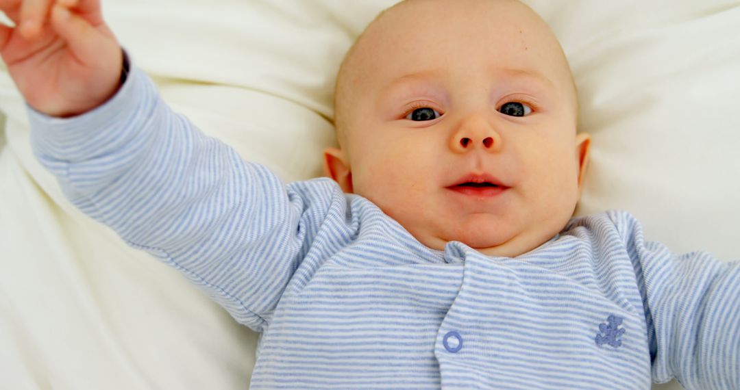 Smiling Baby Boy Stretching Arms in Cozy Home Setting
