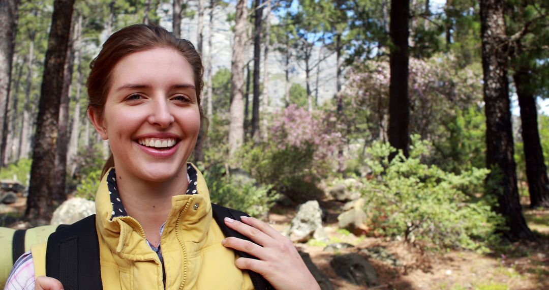 Smiling Woman Hiking in Forest Enjoying Nature Adventure