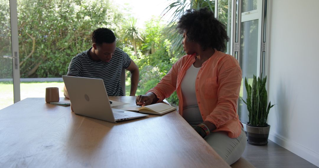 Couple Collaborating on Project in Home Office Setting