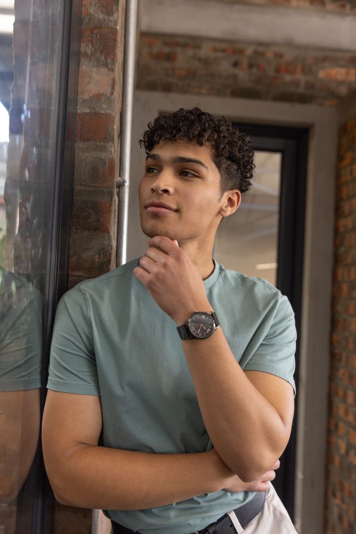 Confident Man in Modern Coworking Space Checking Time