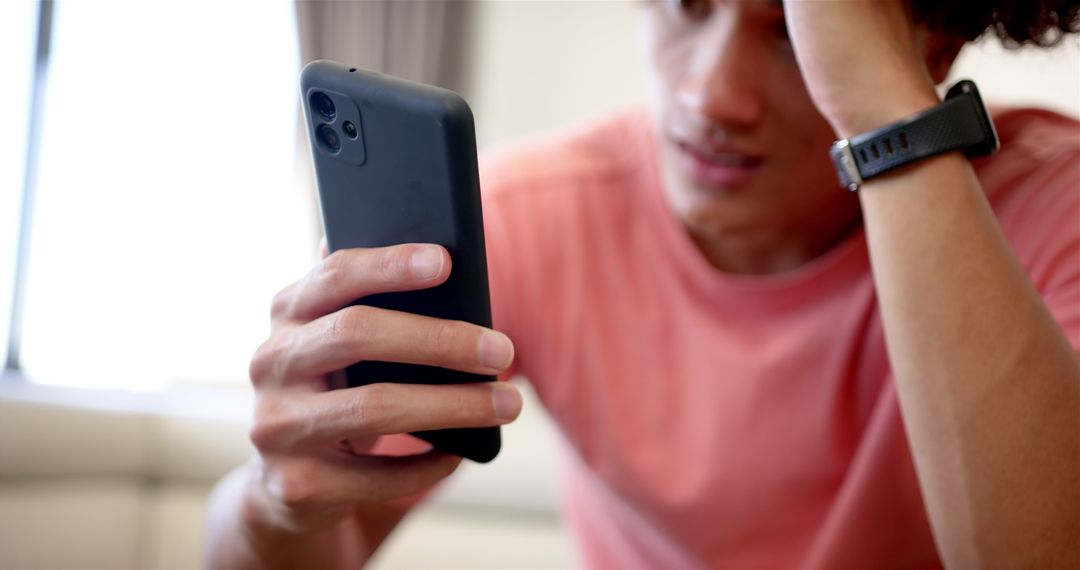 Young Man Stressed While Checking Smartphone