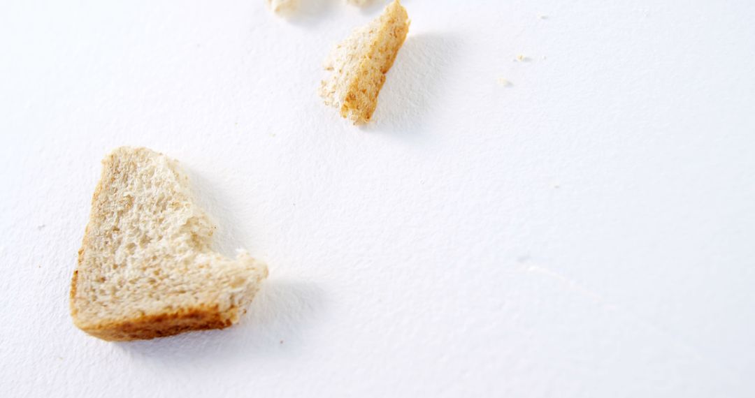 Pieces of bread crumbs on white table - Free Images, Stock Photos and Pictures on Pikwizard.com