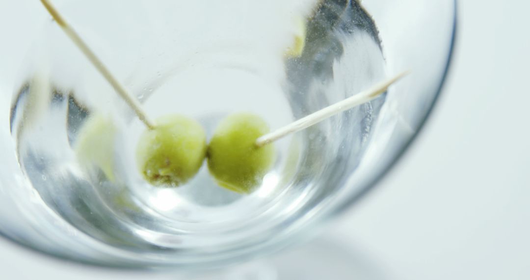 Close-up of Olives on Toothpicks in an Empty Martini Glass - Free Images, Stock Photos and Pictures on Pikwizard.com