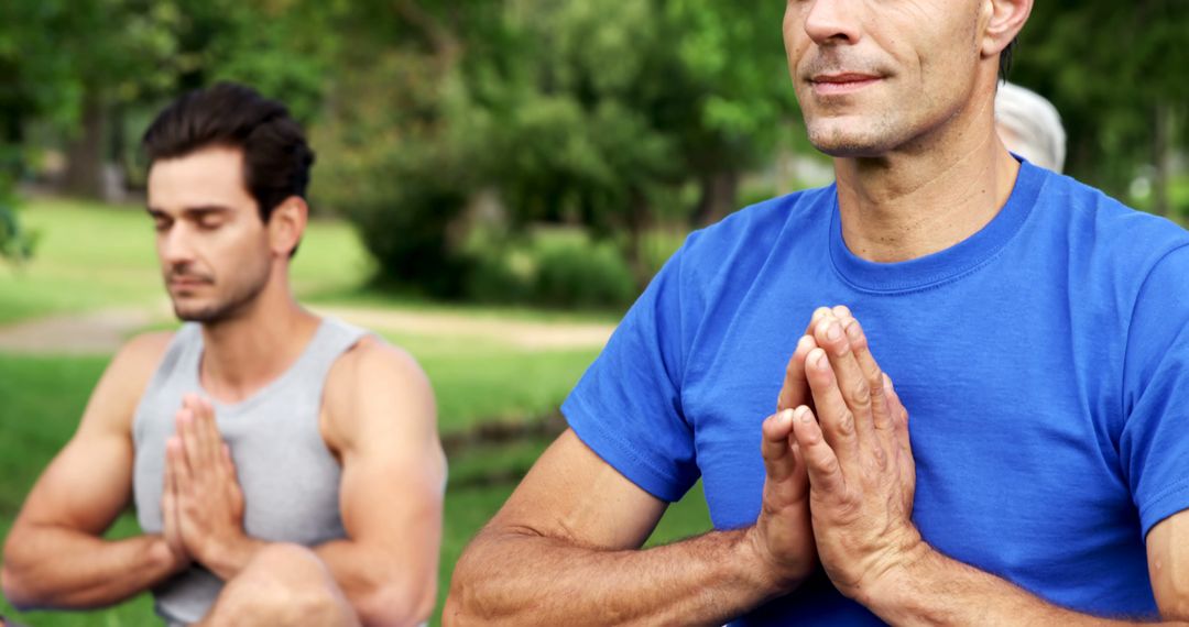 Two Men Practicing Yoga Outdoors in Peaceful Park - Free Images, Stock Photos and Pictures on Pikwizard.com