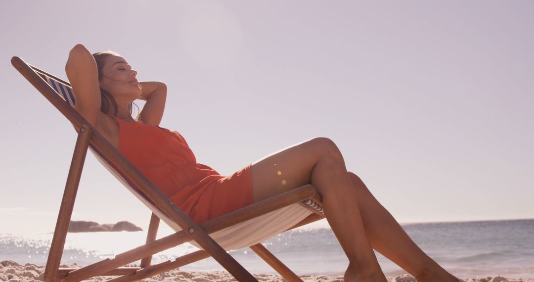 Woman Relaxing on Beach in Lounge Chair Under Sun - Free Images, Stock Photos and Pictures on Pikwizard.com