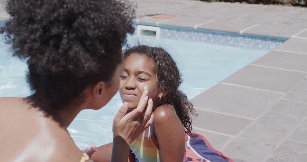 Mother Applying Sunscreen on Daughter by Swimming Pool - Free Images, Stock Photos and Pictures on Pikwizard.com