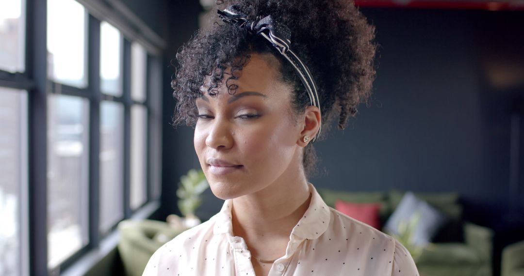 Confident Black Woman with Curly Hair in Modern Office - Free Images, Stock Photos and Pictures on Pikwizard.com