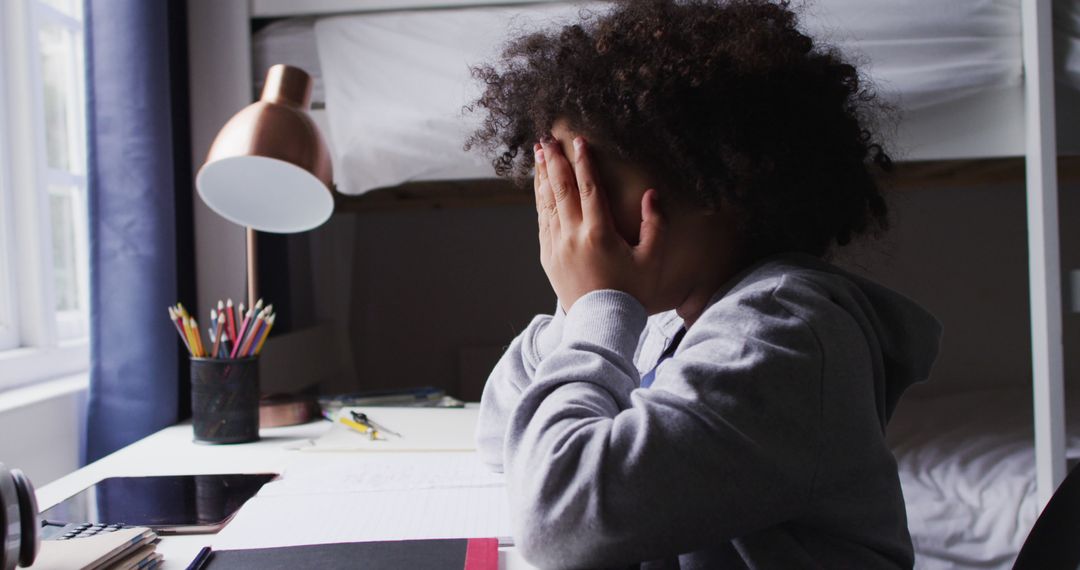 Stressed Child Covering Face While Doing Homework - Free Images, Stock Photos and Pictures on Pikwizard.com