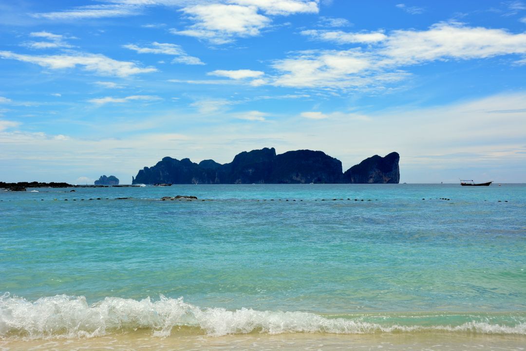Serene Beach with Clear Blue Water and Distant Islands - Free Images, Stock Photos and Pictures on Pikwizard.com