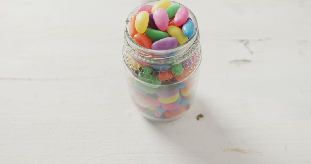 Colorful Candy Jelly Beans in Glass Jar on White Table - Free Images, Stock Photos and Pictures on Pikwizard.com