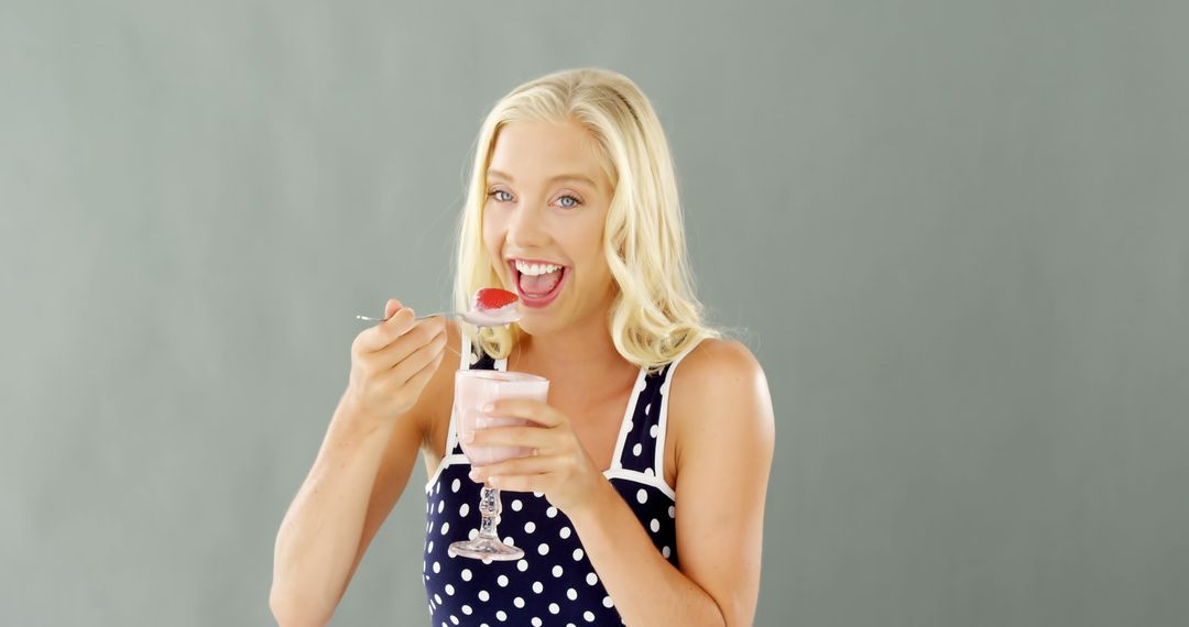 Smiling Blonde Woman Eating Strawberry Yogurt - Free Images, Stock Photos and Pictures on Pikwizard.com