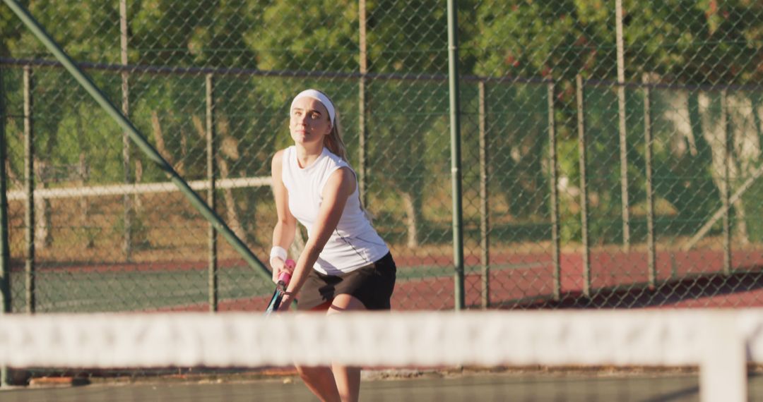 Young Woman Playing Tennis at Outdoor Court - Free Images, Stock Photos and Pictures on Pikwizard.com