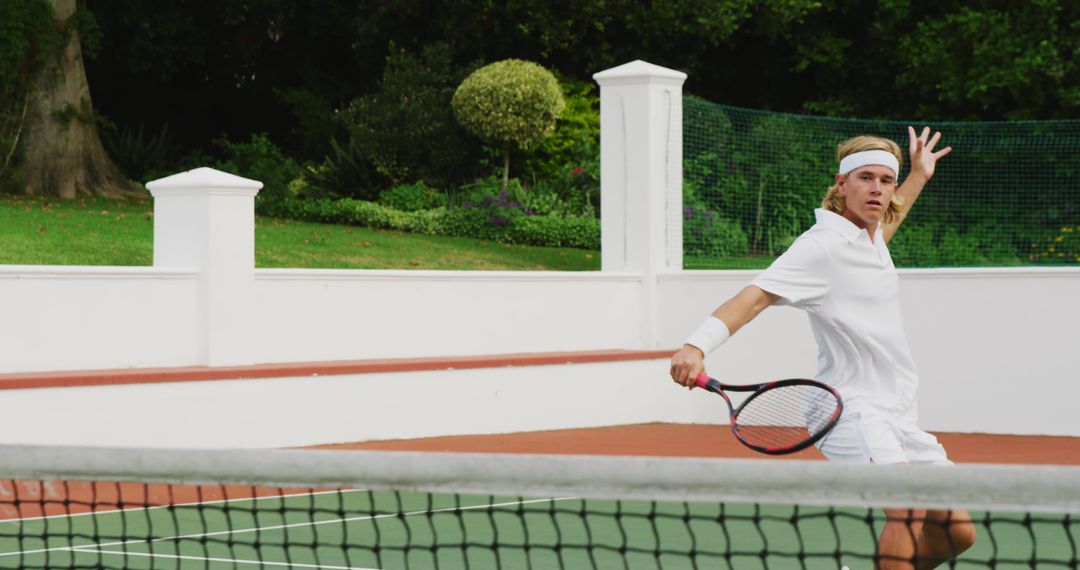 Young Male Tennis Player Hitting Backhand Shot on Court - Free Images, Stock Photos and Pictures on Pikwizard.com