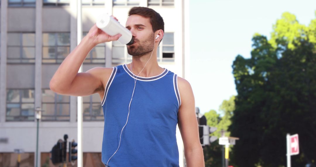 Young Man Hydrating After Outdoor Workout - Free Images, Stock Photos and Pictures on Pikwizard.com