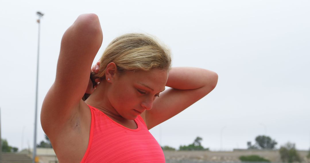 Female Athlete Adjusting Hair Before Outdoor Workout - Free Images, Stock Photos and Pictures on Pikwizard.com