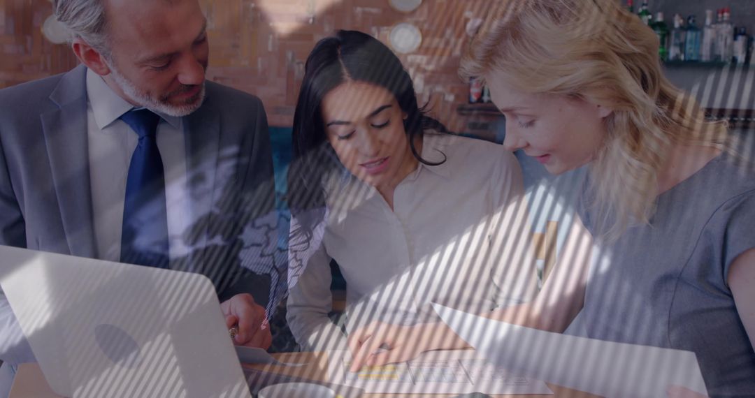 Professional Team Analyzing Documents in Modern Lounge