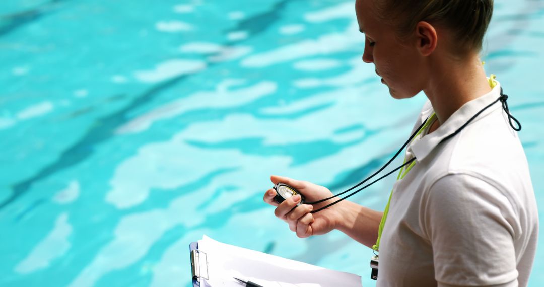 Female Swim Coach Timing Performance by Poolside - Free Images, Stock Photos and Pictures on Pikwizard.com