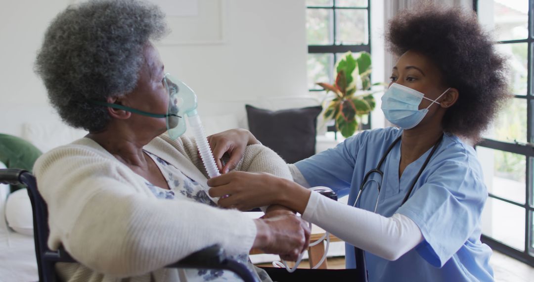 Healthcare Worker Assisting Elderly Patient with Oxygen Mask - Free Images, Stock Photos and Pictures on Pikwizard.com