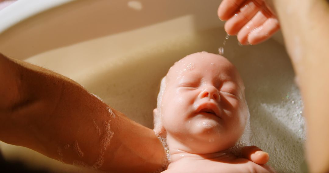 Parent Bathing Newborn Baby in Warm Soapy Water - Free Images, Stock Photos and Pictures on Pikwizard.com