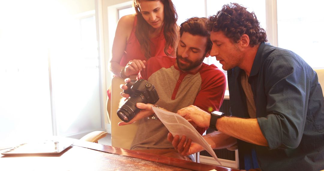 Group of Photographers Reviewing Photos on Camera - Free Images, Stock Photos and Pictures on Pikwizard.com