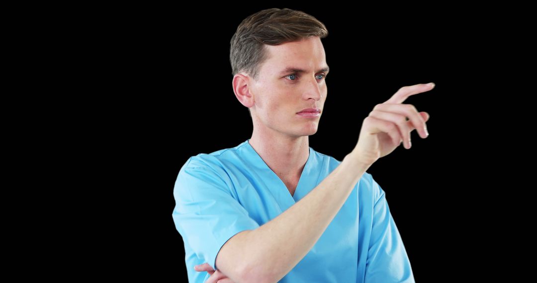 Male Nurse Gesturing With Focus in Blue Scrubs on Black Background - Free Images, Stock Photos and Pictures on Pikwizard.com