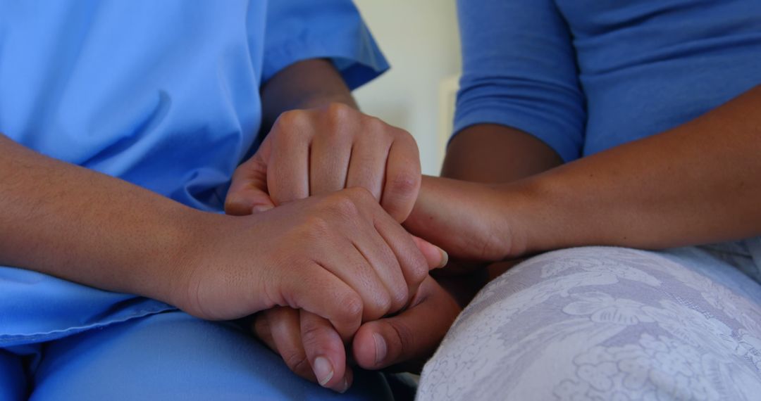 Close-up of healthcare provider comforting patient by holding hands - Free Images, Stock Photos and Pictures on Pikwizard.com