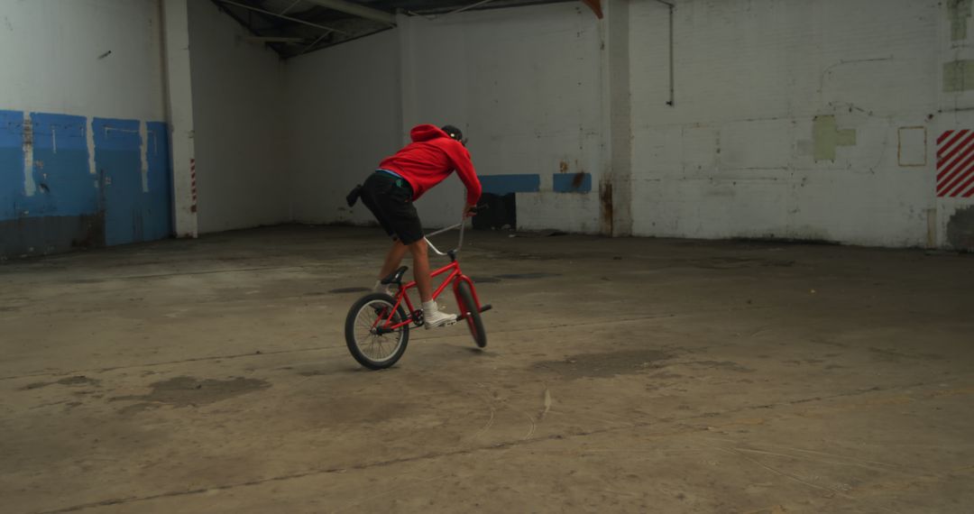 Person Performing Stunt on BMX Bike in Abandoned Warehouse - Free Images, Stock Photos and Pictures on Pikwizard.com