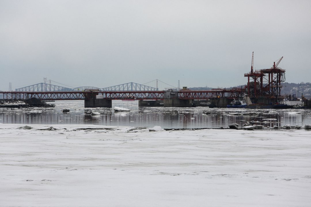 Construction Site of Bridge Over Frozen River in Winter - Free Images, Stock Photos and Pictures on Pikwizard.com