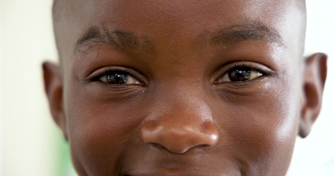 Close-Up Portrait of Smiling African American Boy with Vibrant Expression