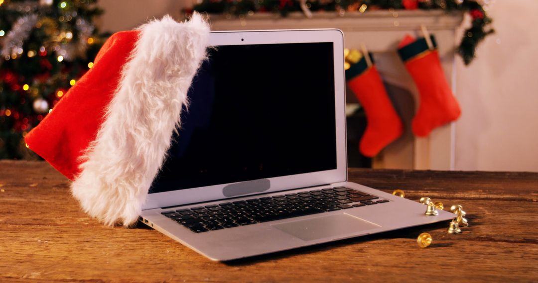 Festive Laptop with Santa Hat on Wooden Table - Free Images, Stock Photos and Pictures on Pikwizard.com