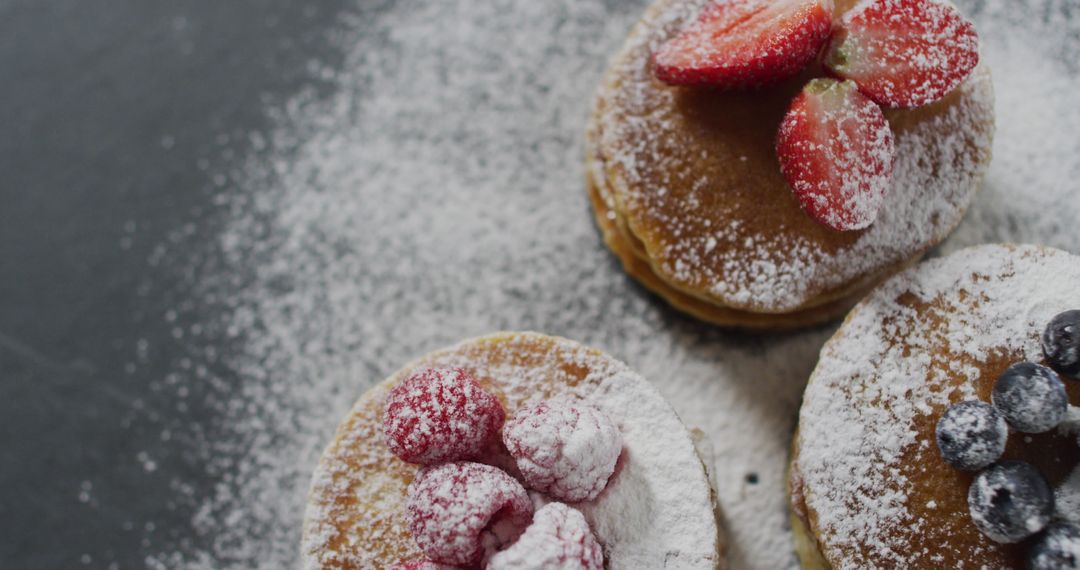 Delicious Pancakes Topped with Fresh Berries and Sugar