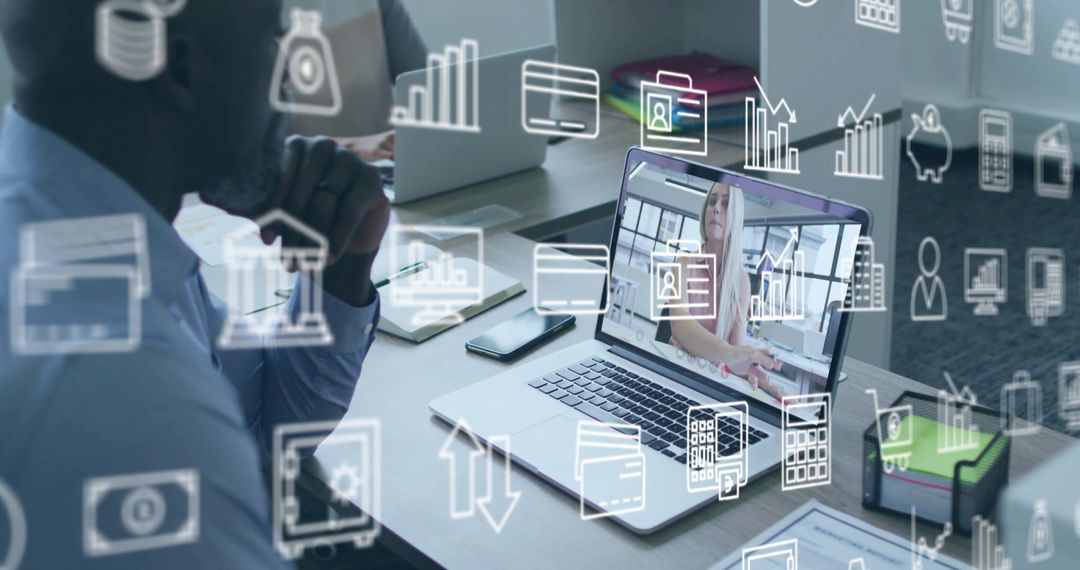 Mature man collaborating in conference room using laptop with virtual business icons overlay