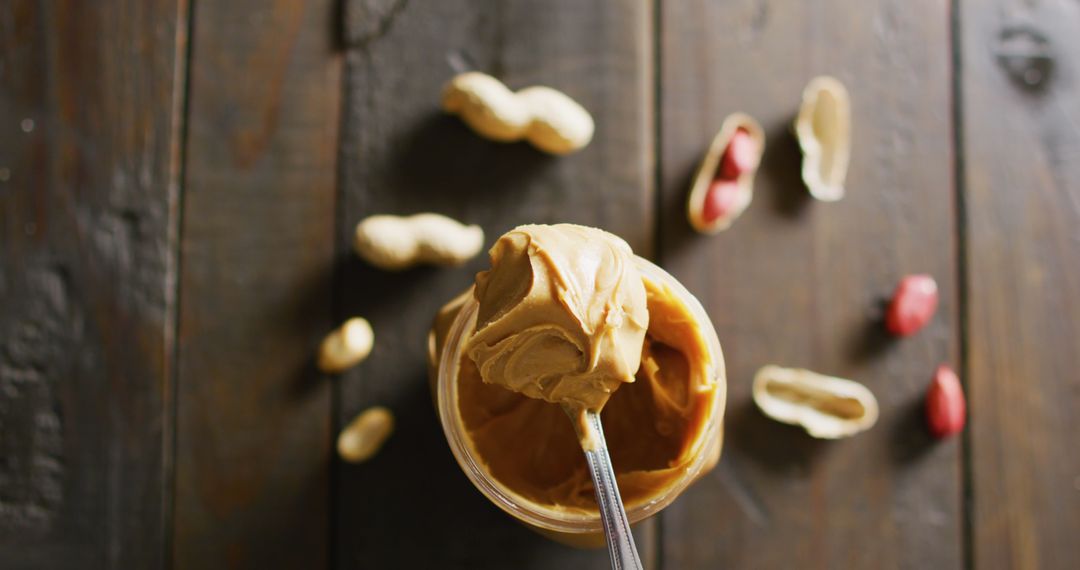 Close-up of Creamy Peanut Butter with Peanuts on Rustic Wooden Background - Free Images, Stock Photos and Pictures on Pikwizard.com