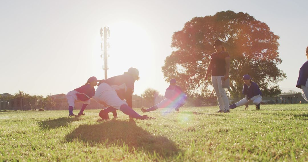 Youth Baseball Team Stretching During Practice at Sunset - Free Images, Stock Photos and Pictures on Pikwizard.com