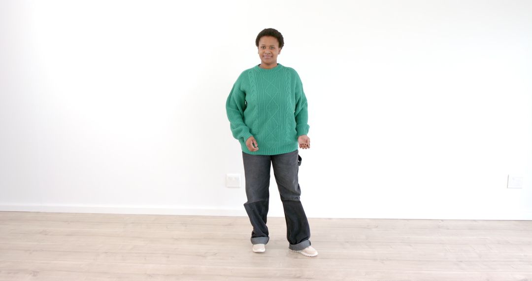 Child Engaged in Playful Indoor Activity with Green Sweater