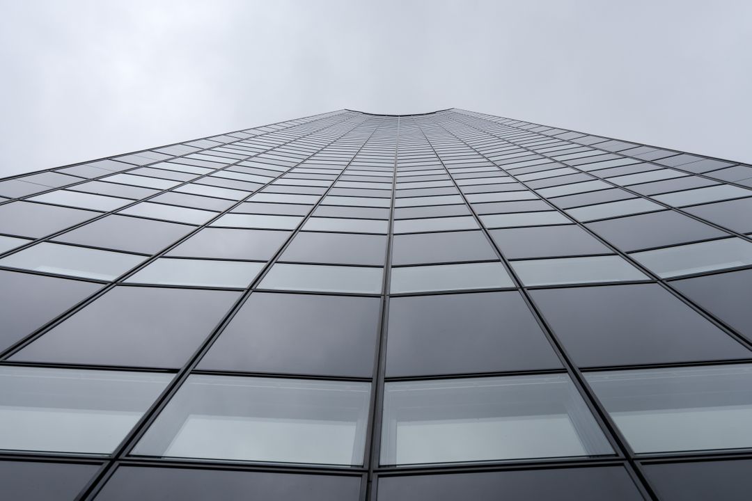 Low Angle View of Modern Skyscraper Against Cloudy Sky - Free Images, Stock Photos and Pictures on Pikwizard.com