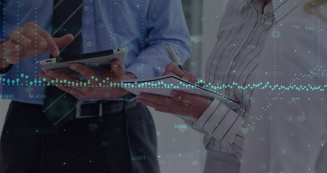 Business Professionals Analyzing Data on Digital Devices