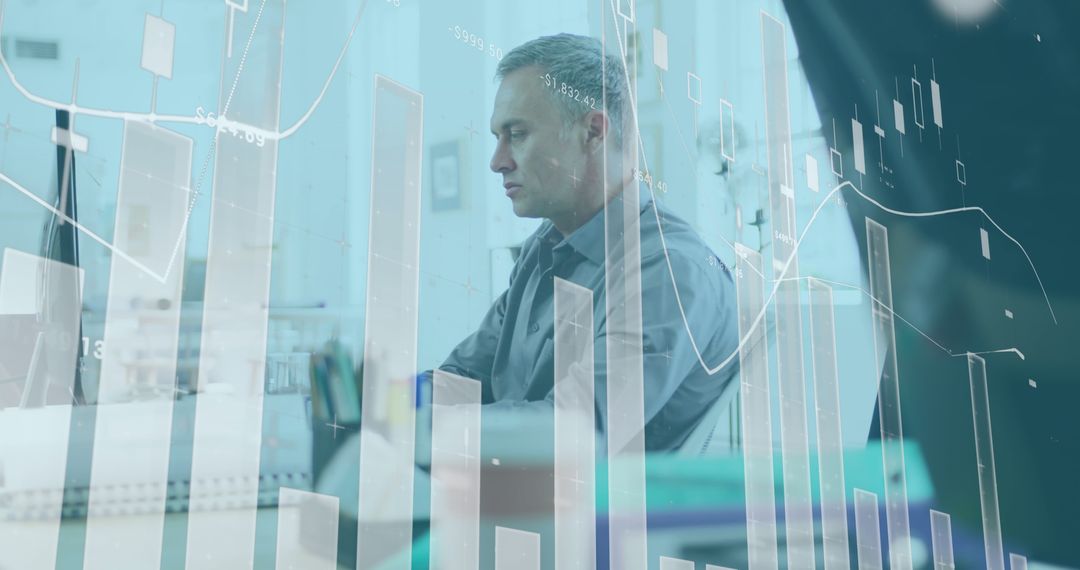 Businessman Analyzing Data at Desk with Financial Graph Overlay - Free Images, Stock Photos and Pictures on Pikwizard.com