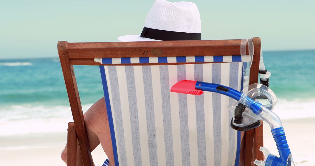 Senior Wearing Hat Relaxing on Beach Chair with Snorkel - Free Images, Stock Photos and Pictures on Pikwizard.com