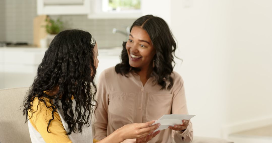 Mother and Daughter Bonding with Letters and Smiles at Home