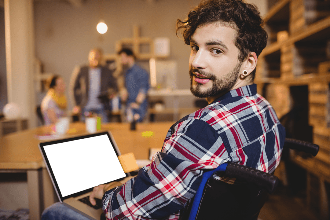 Confident Designer in Wheelchair Using Laptop in Transparent Workspace
