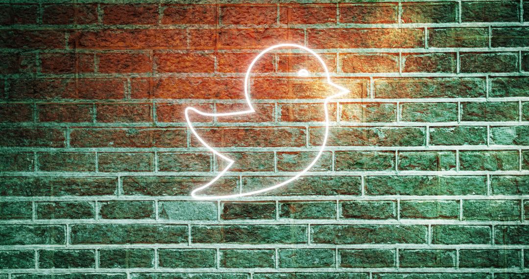 Neon Bird Light on Brick Wall Symbolizing Social Media and Communication