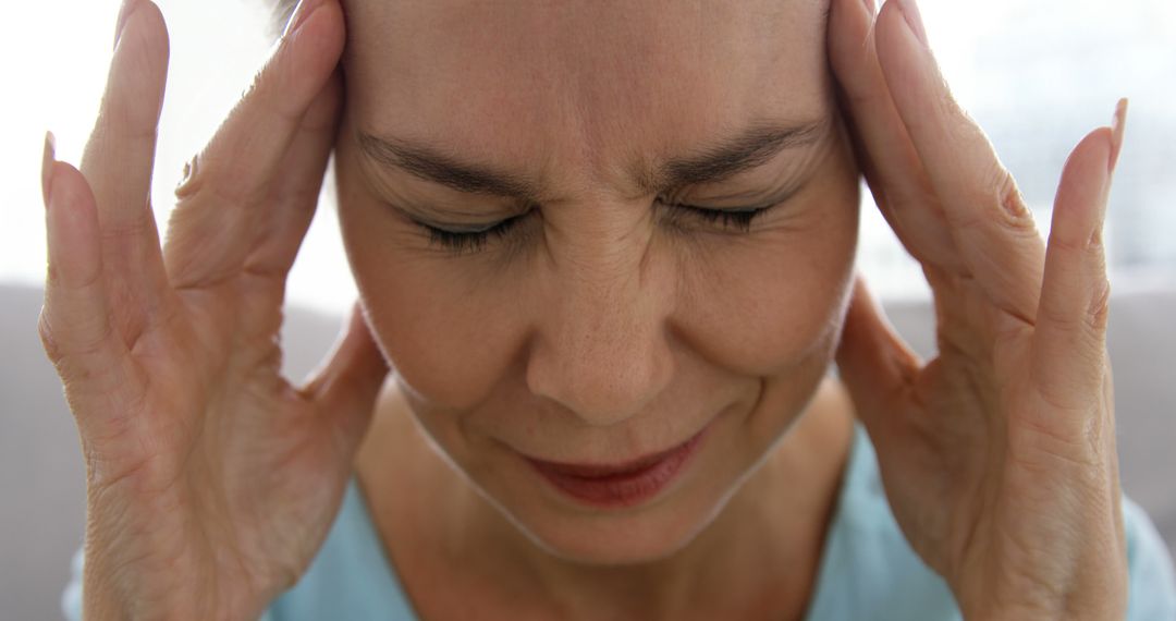 Woman Experiencing a Stressful Headache - Free Images, Stock Photos and Pictures on Pikwizard.com