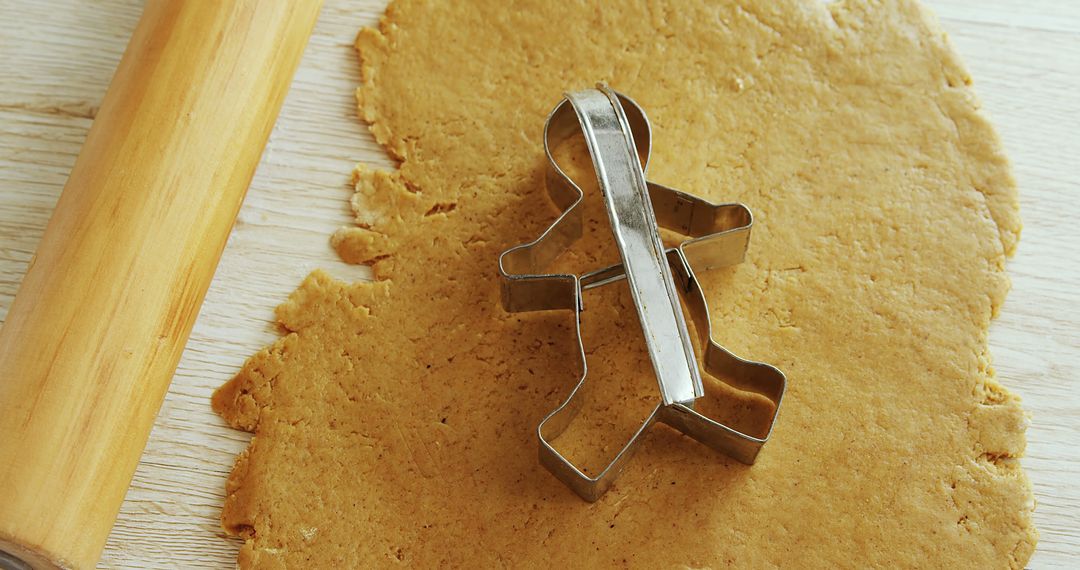 Christmas Gingerbread Cookie Preparation with Cookie Cutter - Free Images, Stock Photos and Pictures on Pikwizard.com