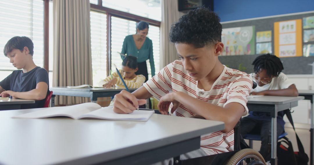 Diverse Classroom with Boy in Wheelchair Engaged in Writing Activity